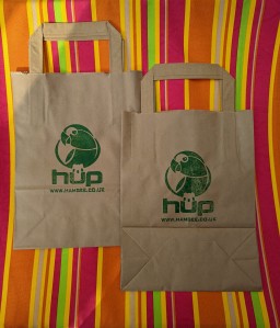 picture of two paper bags on stripy fabric backgrouns