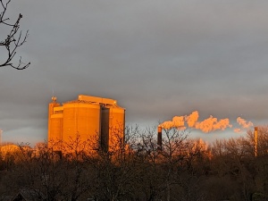 picture of a factory with sunlight shining on it